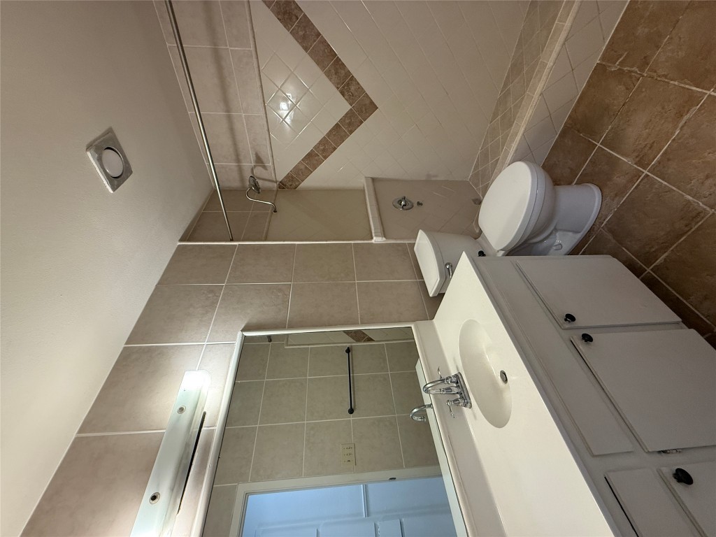 8906 Pineridge Drive Austin, TX 78729 - Photo 24 of 35 a bathroom with a sink toilet and shower