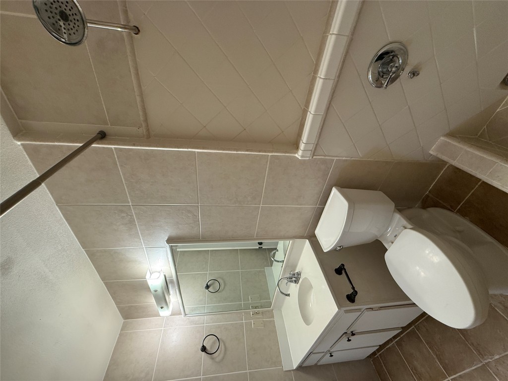 8906 Pineridge Drive Austin, TX 78729 - Photo 25 of 35 a bathroom with a toilet sink and mirror