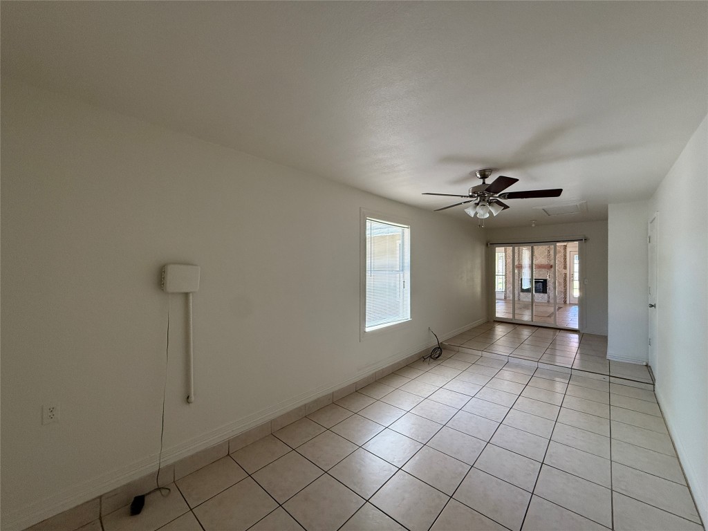 8906 Pineridge Drive Austin, TX 78729 - Photo 27 of 35 a view of a livingroom with a chandelier fan and windows