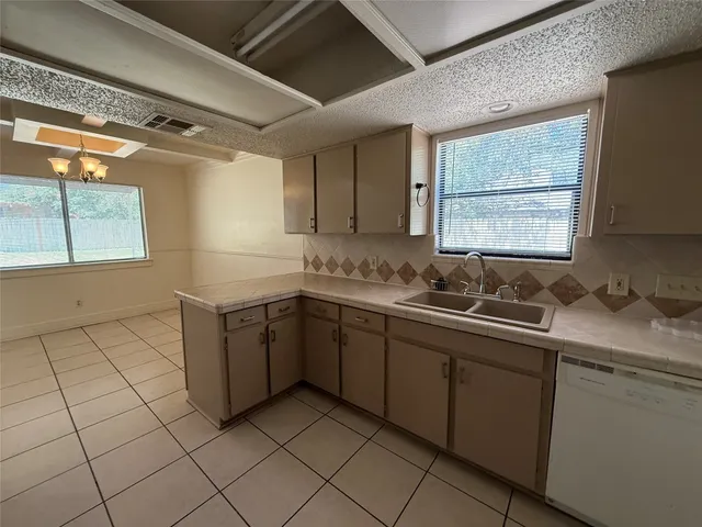 a kitchen with a sink cabinets and window