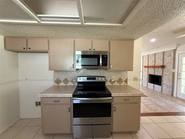 a kitchen with a stove and a microwave