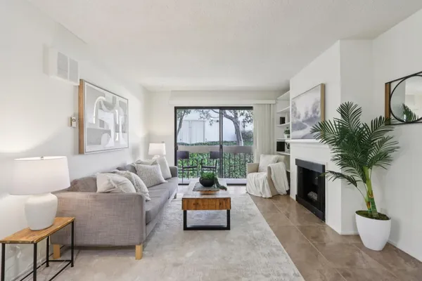 a living room with furniture large window and a fireplace