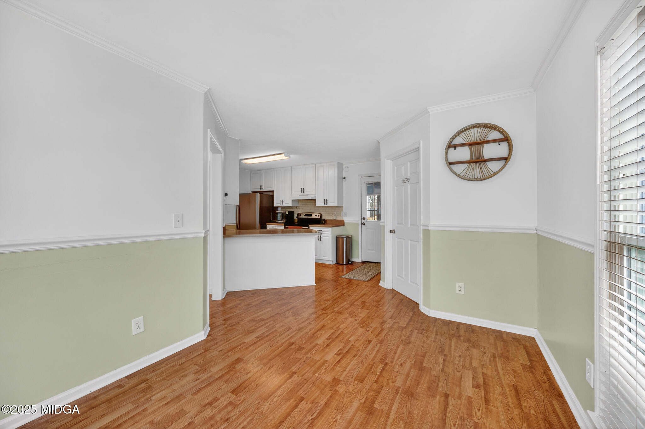 199 Springfield Boulevard Macon, GA 31210 - Photo 21 of 44 a view of kitchen and empty room with wooden floor