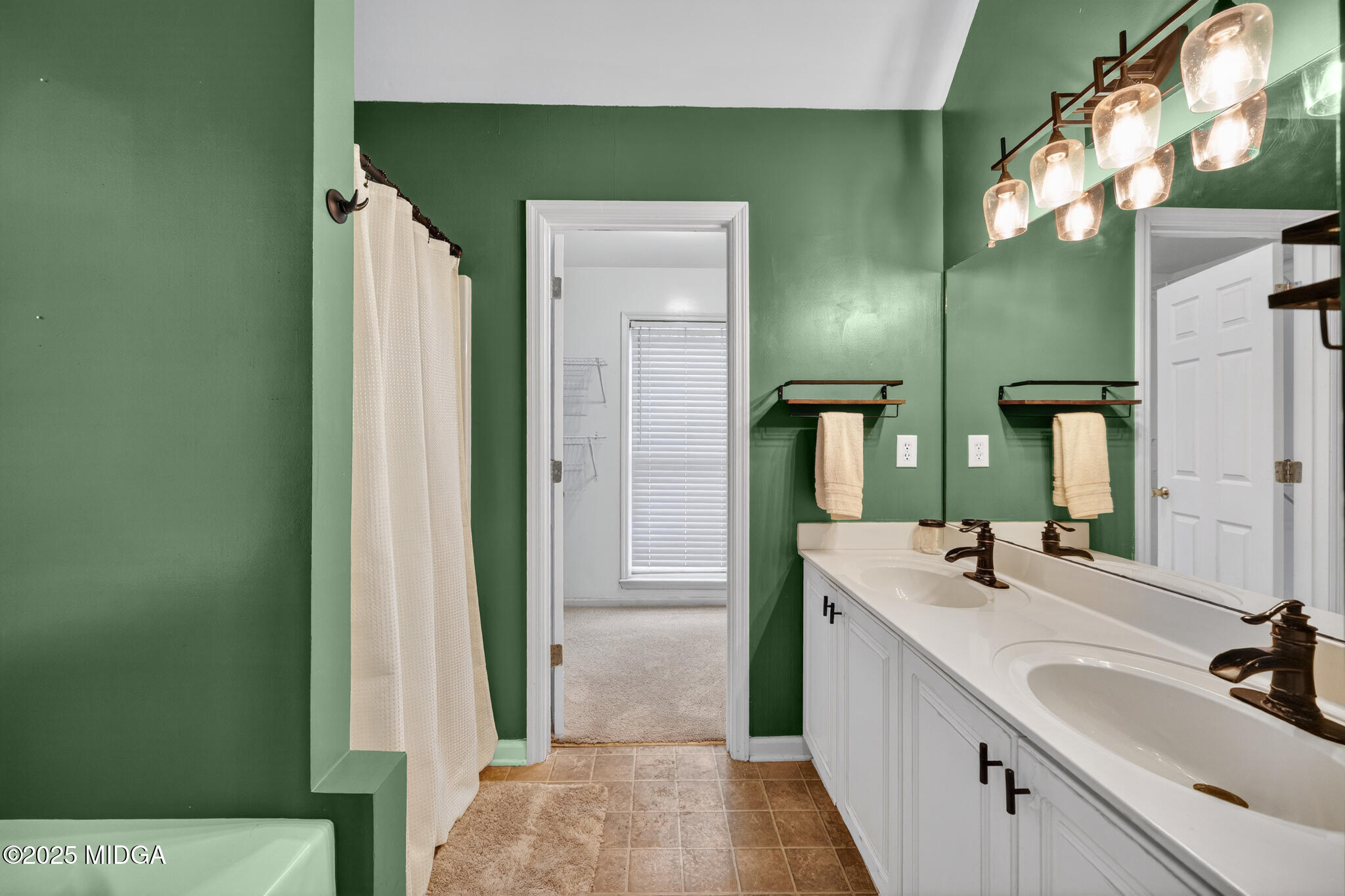 199 Springfield Boulevard Macon, GA 31210 - Photo 27 of 44 a bathroom with a double vanity sink and a mirror