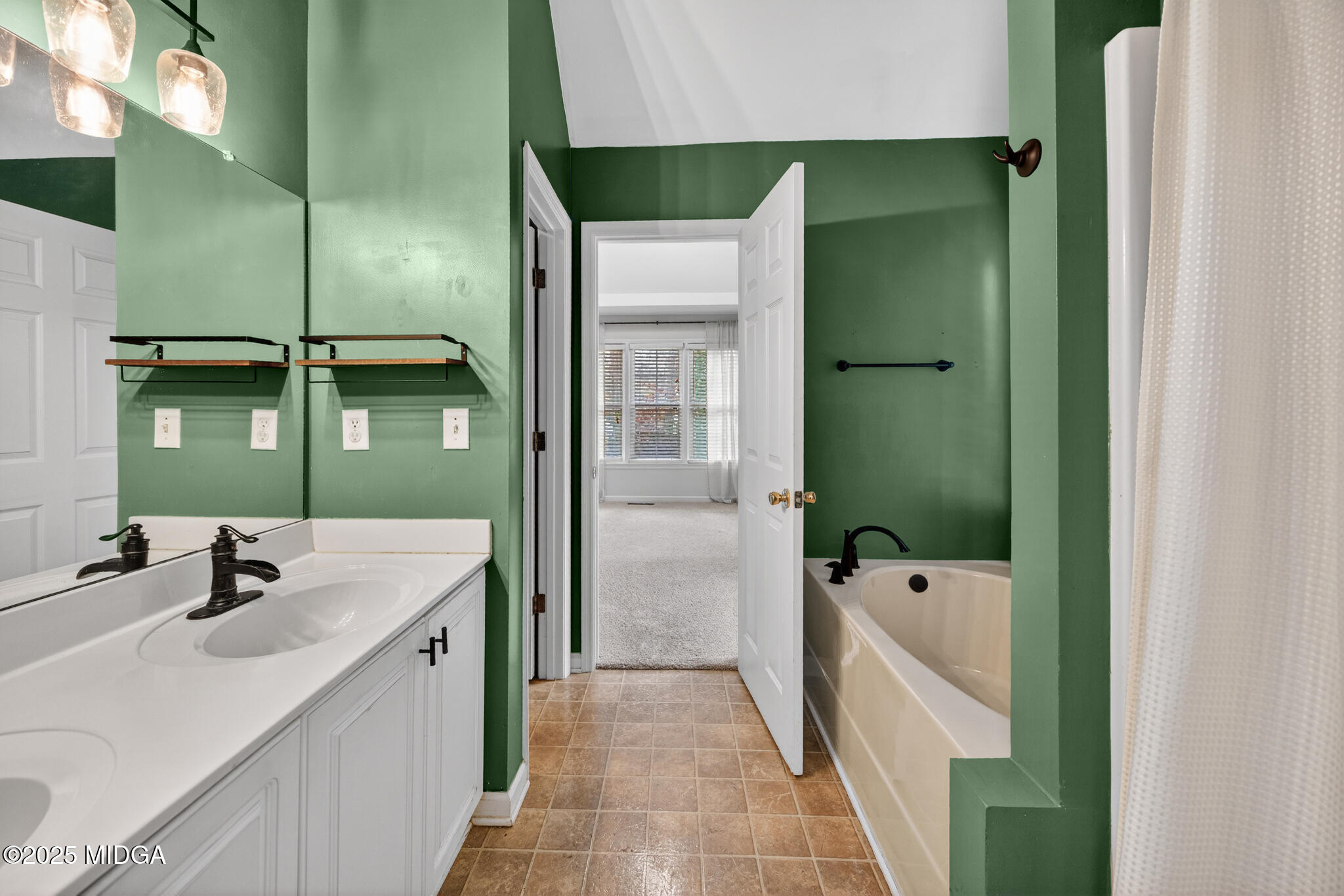 199 Springfield Boulevard Macon, GA 31210 - Photo 28 of 44 a bathroom with a tub sink and mirror
