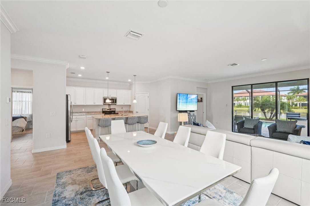 11872 Arbor Trace Drive Fort Myers, FL 33913 - Photo 12 of 50 a large white kitchen with a white table and chairs