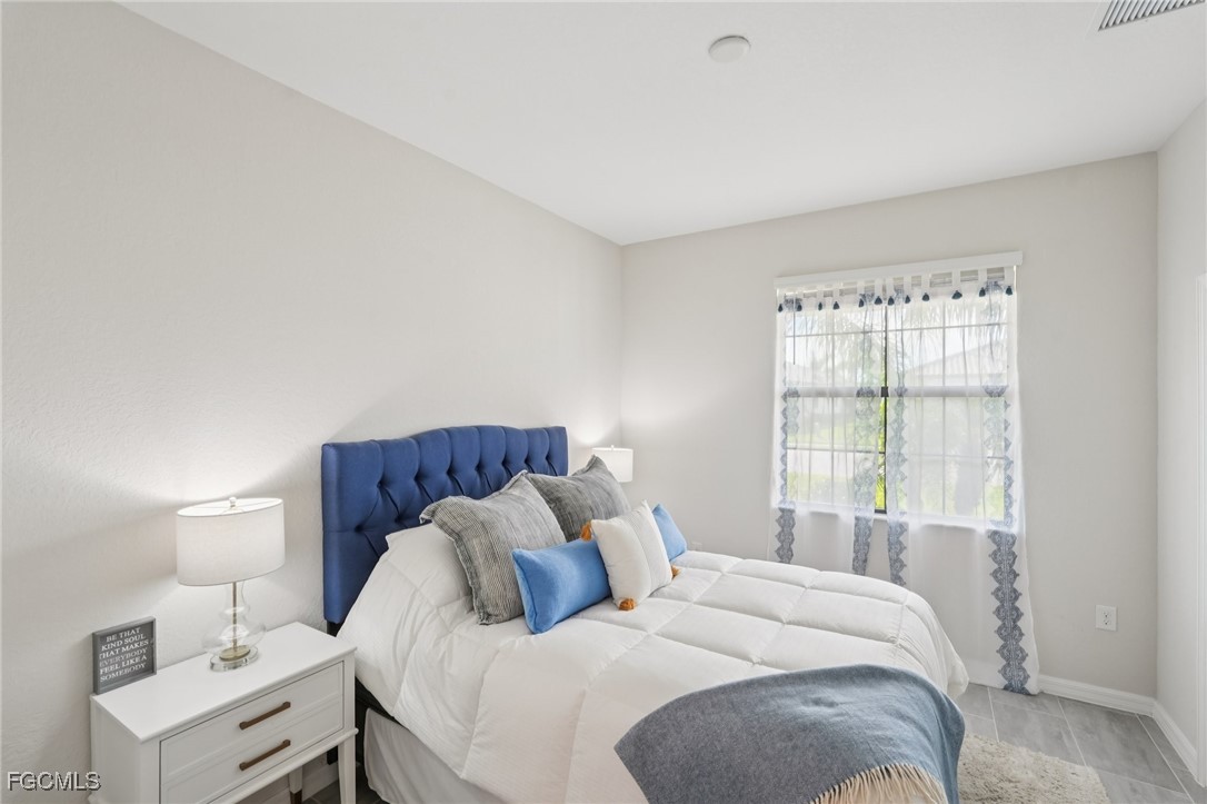 11872 Arbor Trace Drive Fort Myers, FL 33913 - Photo 13 of 50 a bedroom with a bed and a window