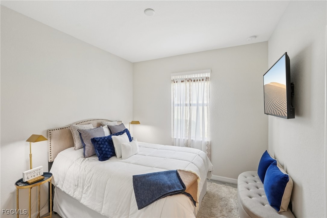 11872 Arbor Trace Drive Fort Myers, FL 33913 - Photo 16 of 50 a bedroom with a bed and wooden floor