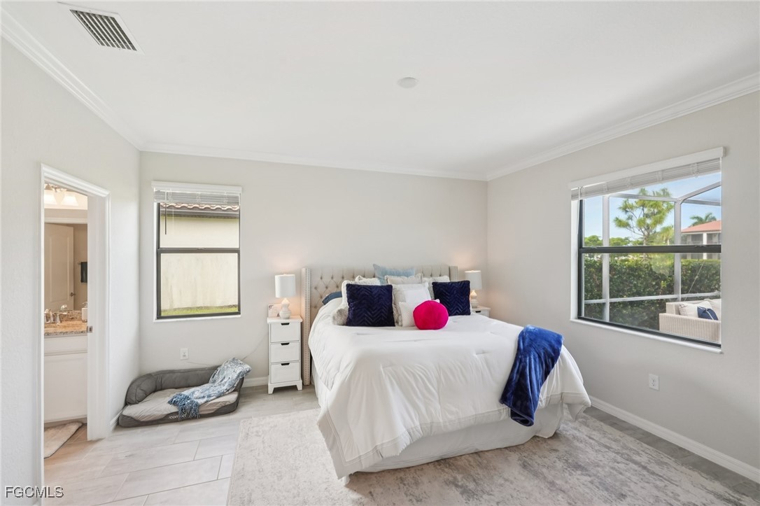 11872 Arbor Trace Drive Fort Myers, FL 33913 - Photo 19 of 50 a bedroom with a bed and windows
