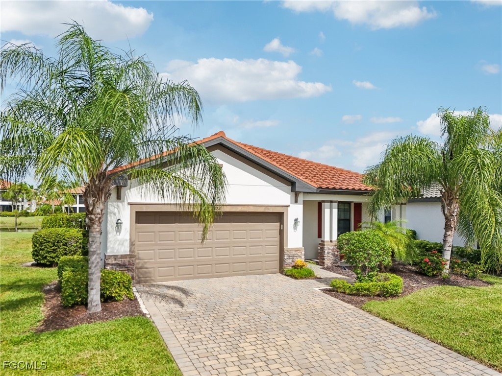 11872 Arbor Trace Drive Fort Myers, FL 33913 - Photo 29 of 50 a small white house with a white roof and table and chairs next to window