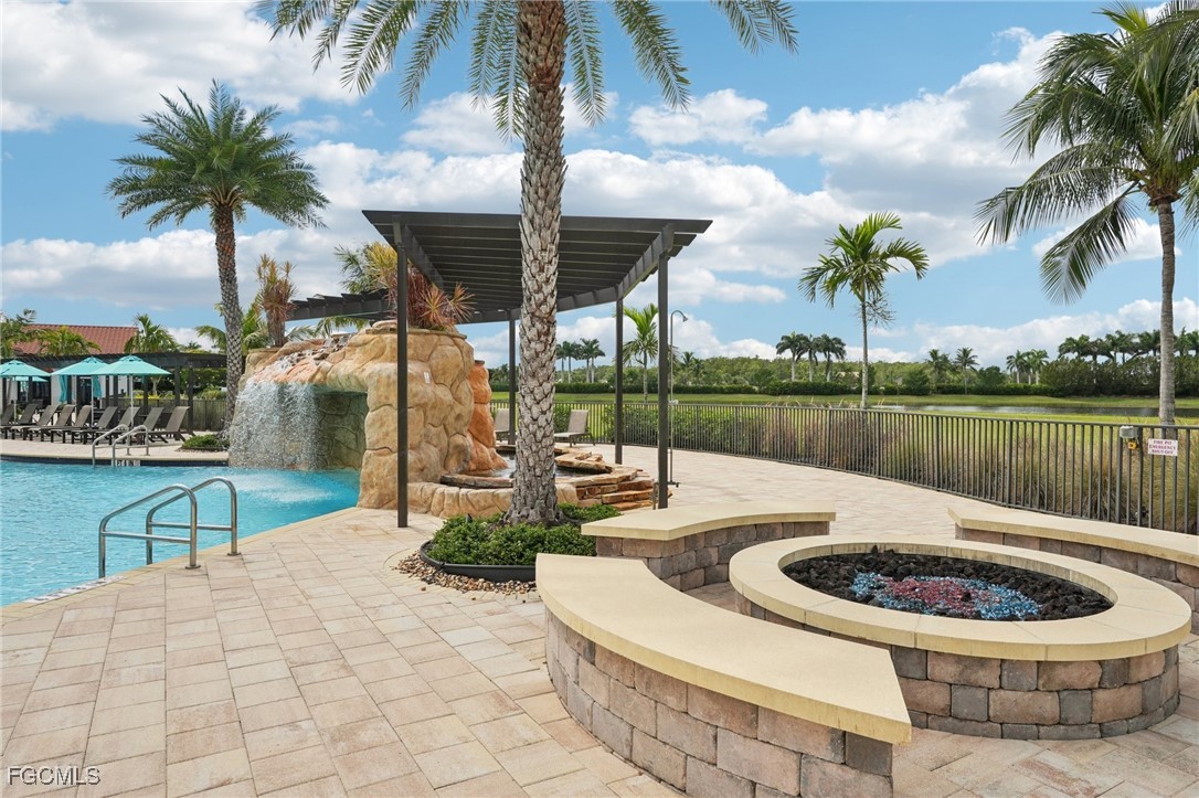 11872 Arbor Trace Drive Fort Myers, FL 33913 - Photo 43 of 50 a view of a swimming pool with a patio and a garden