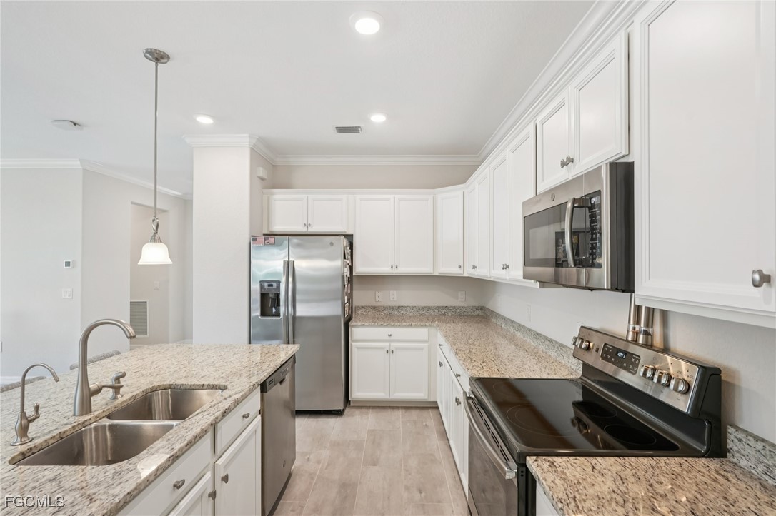 11872 Arbor Trace Drive Fort Myers, FL 33913 - Photo 10 of 50 a kitchen with a sink stove and refrigerator