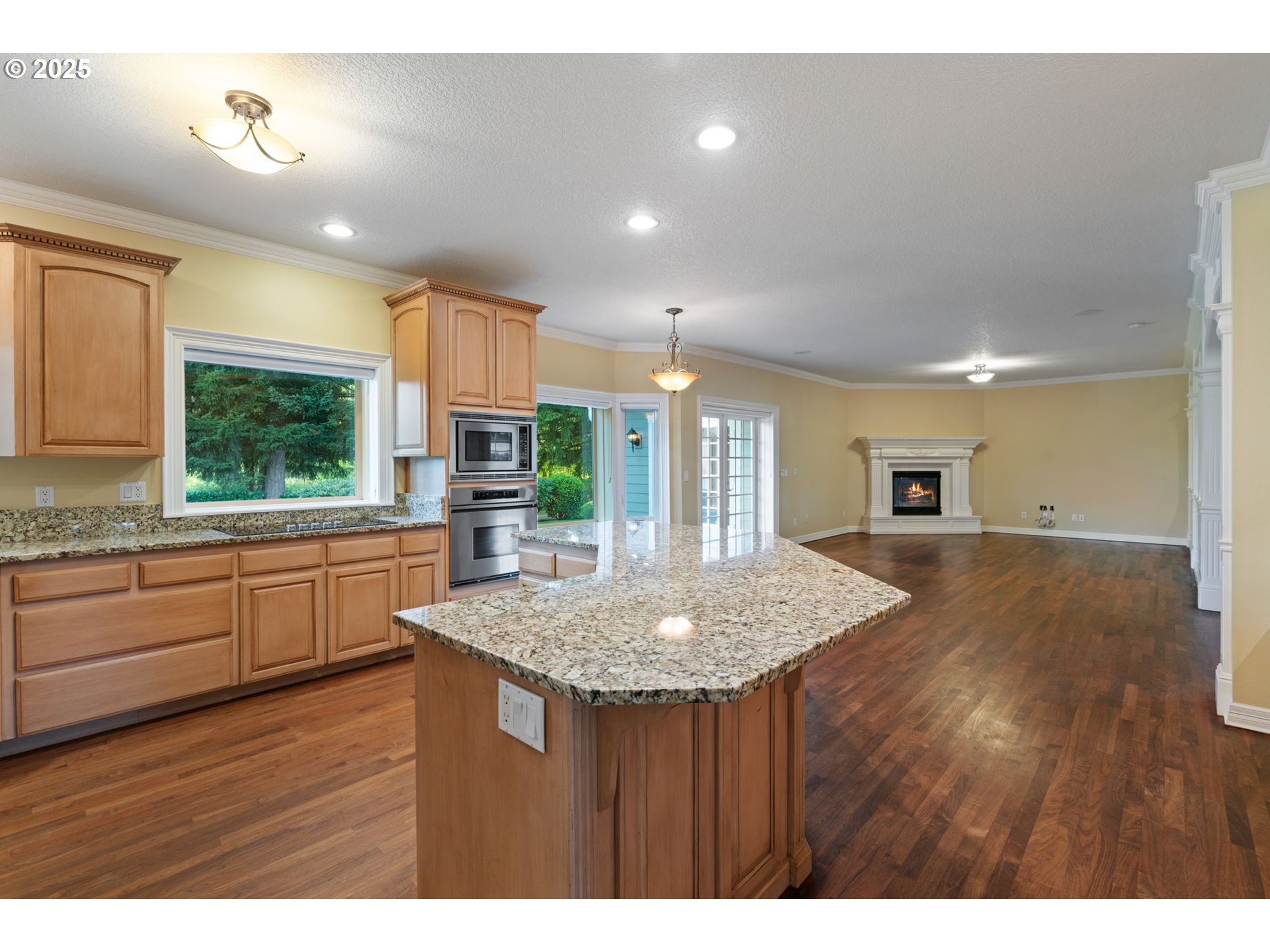 3110 Northwest Lacamas Drive Camas, WA 98607 - Photo 17 of 48 a kitchen with kitchen island granite countertop wooden floors and wide window