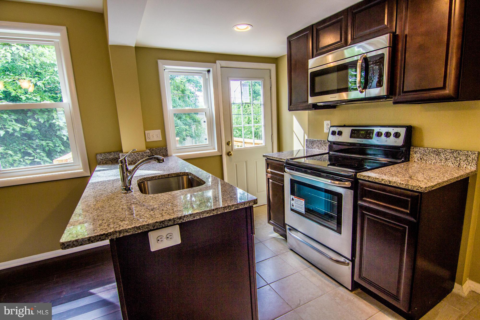 222 Old Riverside Road Baltimore, MD 21225 - Photo 8 of 24 a kitchen with a stove and a sink