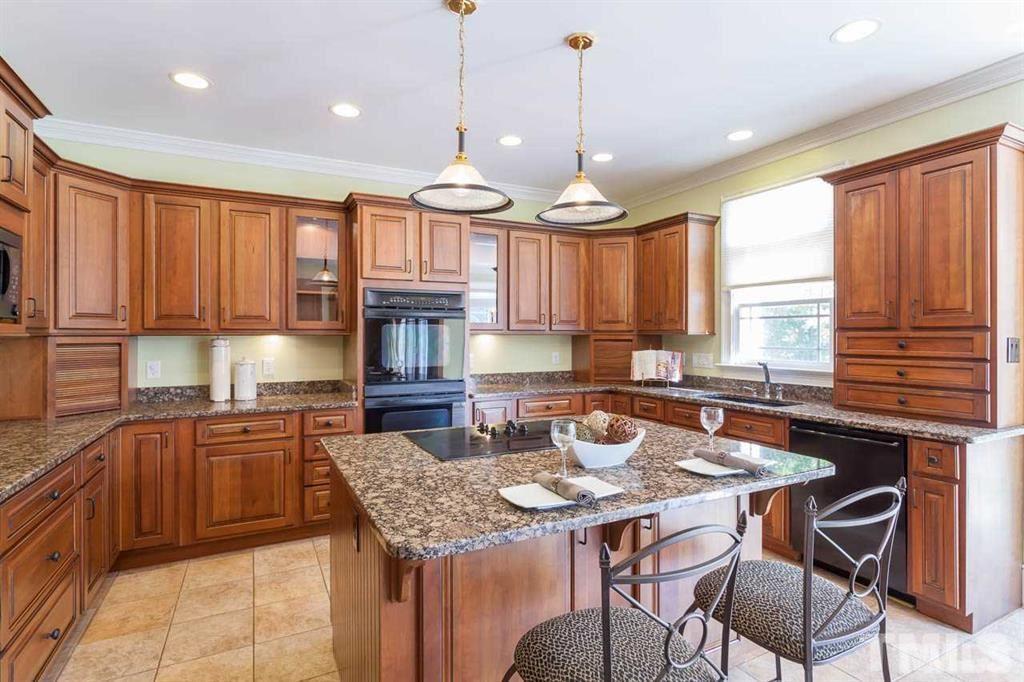 10500 Charmford Way Raleigh, NC 27615 - Photo 12 of 22 a kitchen with a table chairs stove and cabinets