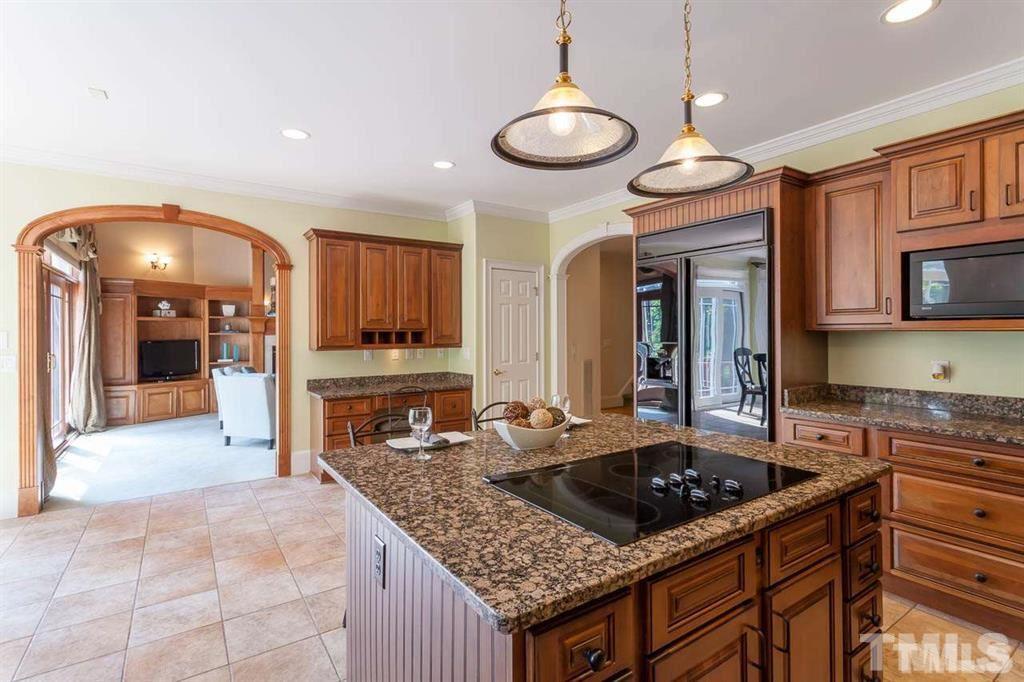 10500 Charmford Way Raleigh, NC 27615 - Photo 14 of 22 a kitchen with stainless steel appliances granite countertop a stove oven and a refrigerator with cabinets