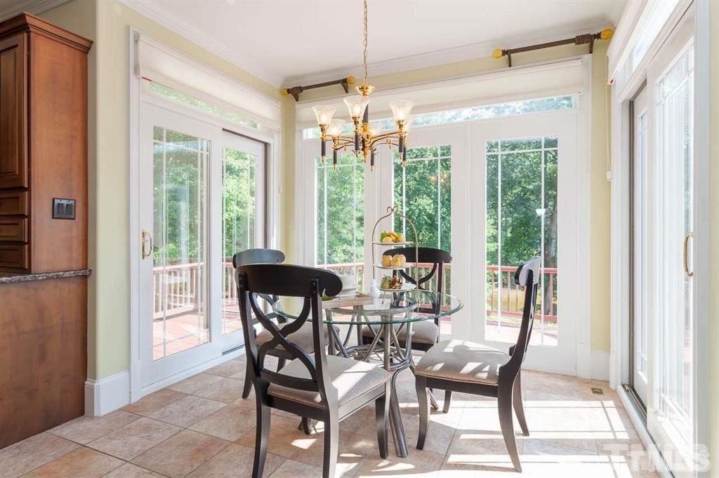 10500 Charmford Way Raleigh, NC 27615 - Photo 15 of 22 a view of a dining room with furniture large windows and wooden floor