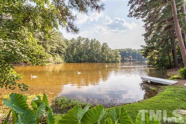10500 Charmford Way Raleigh, NC 27615 - Photo 22 of 22 a view of a lake with houses in the back yard