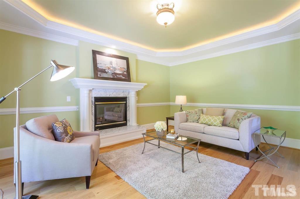 10500 Charmford Way Raleigh, NC 27615 - Photo 8 of 22 a living room with furniture and a fireplace