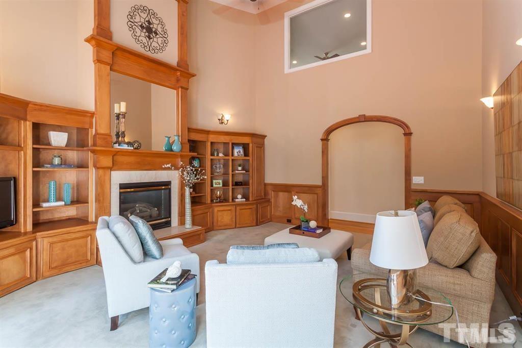 10500 Charmford Way Raleigh, NC 27615 - Photo 10 of 22 a living room with furniture a fireplace and wall painting