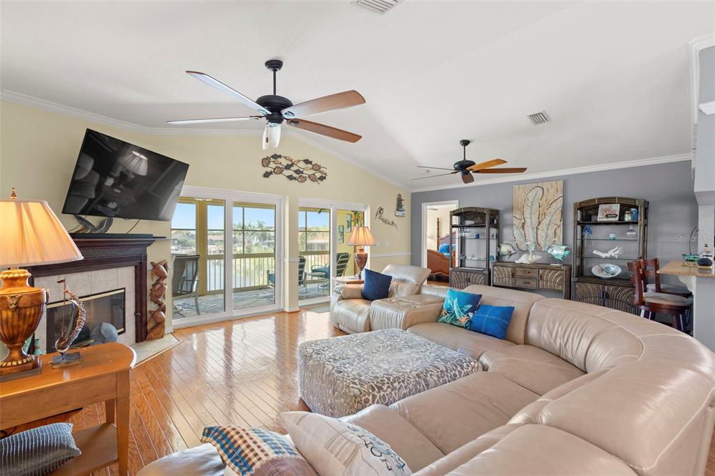 6170 Seaside Drive New Port Richey, FL 34652 - Photo 13 of 89 a living room with furniture fireplace and flat screen tv