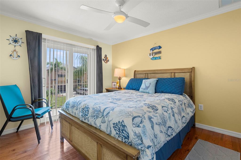 6170 Seaside Drive New Port Richey, FL 34652 - Photo 28 of 89 a bedroom with a bed and wooden floor