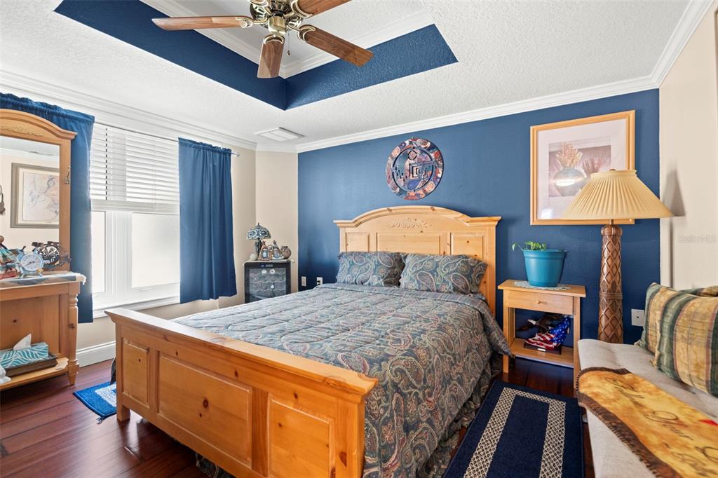 6170 Seaside Drive New Port Richey, FL 34652 - Photo 46 of 89 a bedroom with a bed and wooden floor