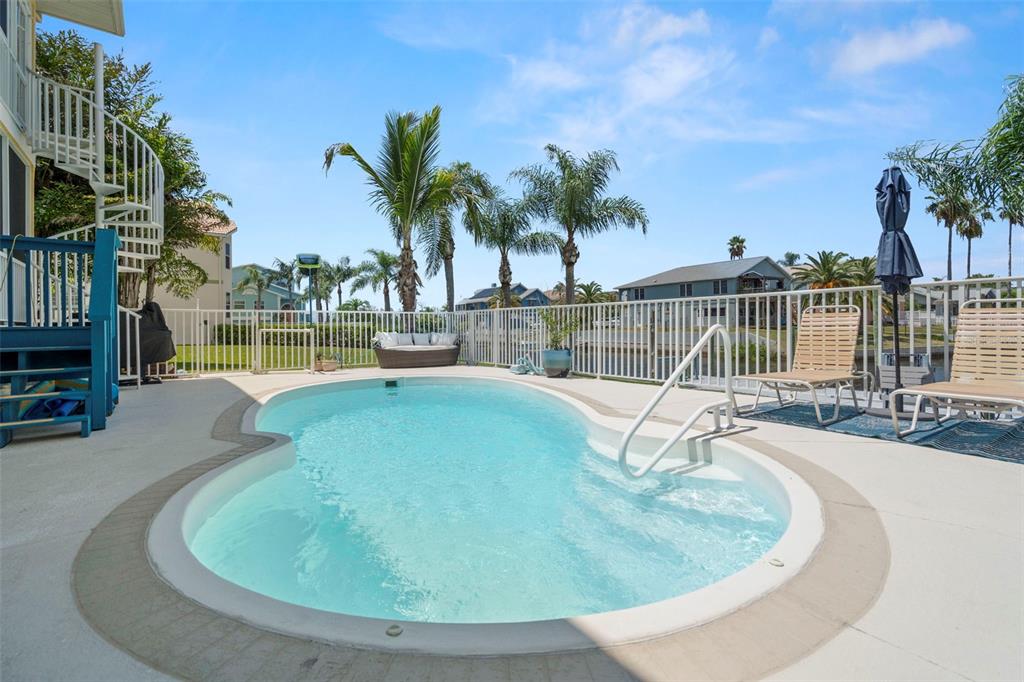 6170 Seaside Drive New Port Richey, FL 34652 - Photo 56 of 89 a view of a swimming pool with a patio and a yard
