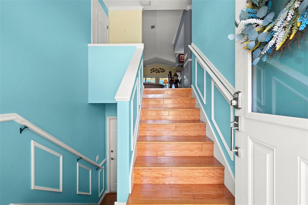 6170 Seaside Drive New Port Richey, FL 34652 - Photo 8 of 89 a view of staircase with lots of frames on wall and a window