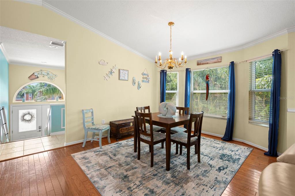 6170 Seaside Drive New Port Richey, FL 34652 - Photo 9 of 89 a view of a dining room with furniture window and wooden floor