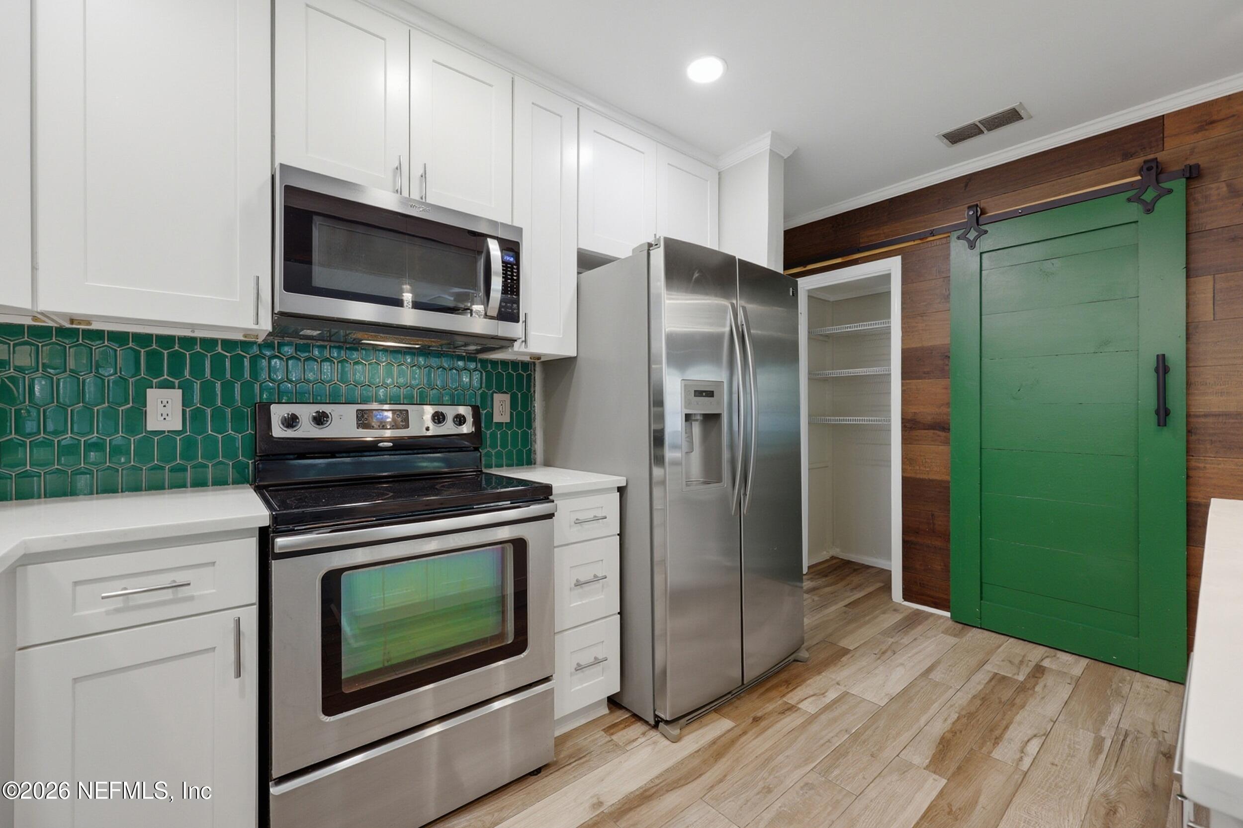 1873 Stanford Road North Jacksonville, FL 32207 - Photo 17 of 37 a kitchen with stainless steel appliances granite countertop a refrigerator stove and microwave