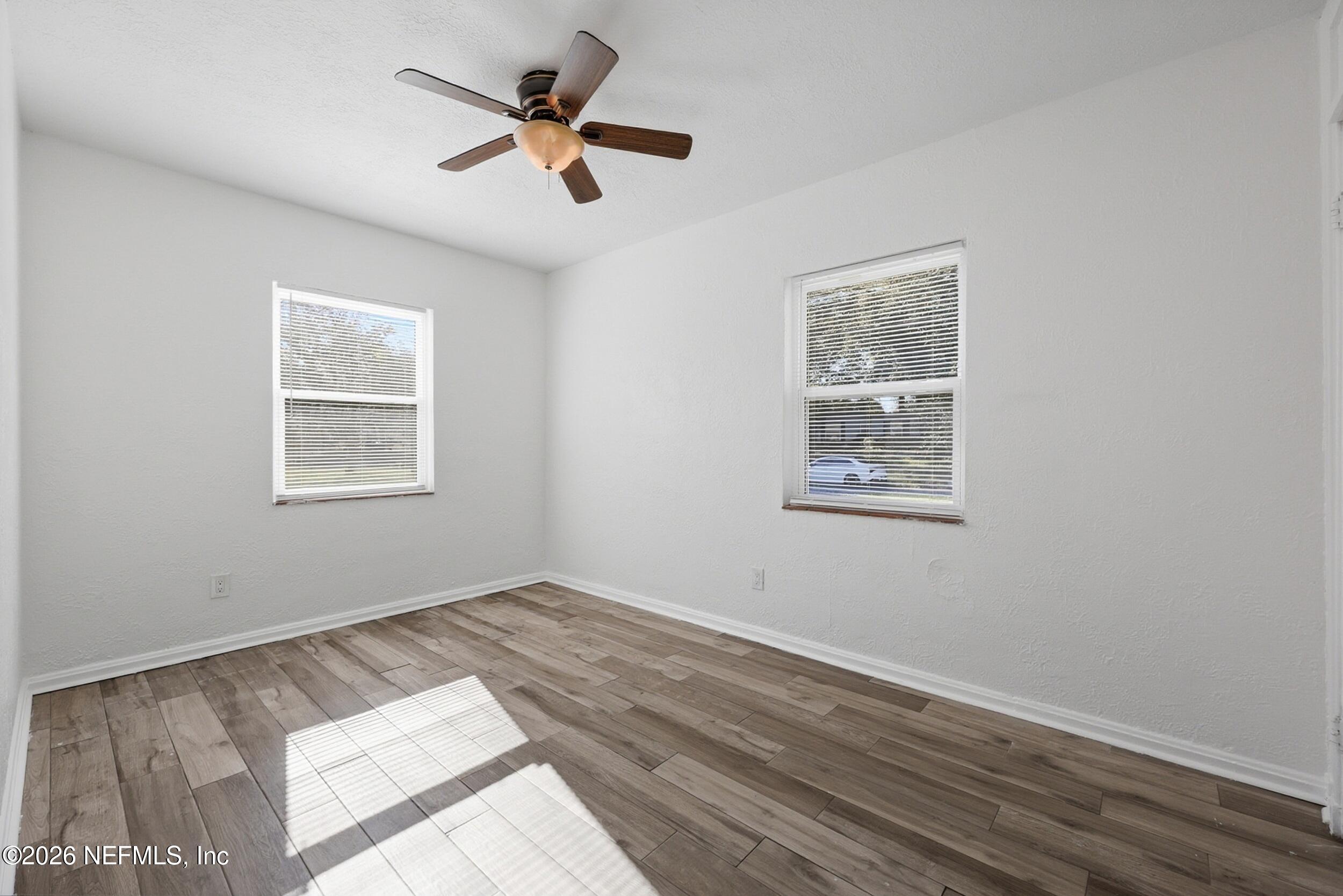 1873 Stanford Road North Jacksonville, FL 32207 - Photo 22 of 37 a view of empty room with wooden floor and fan