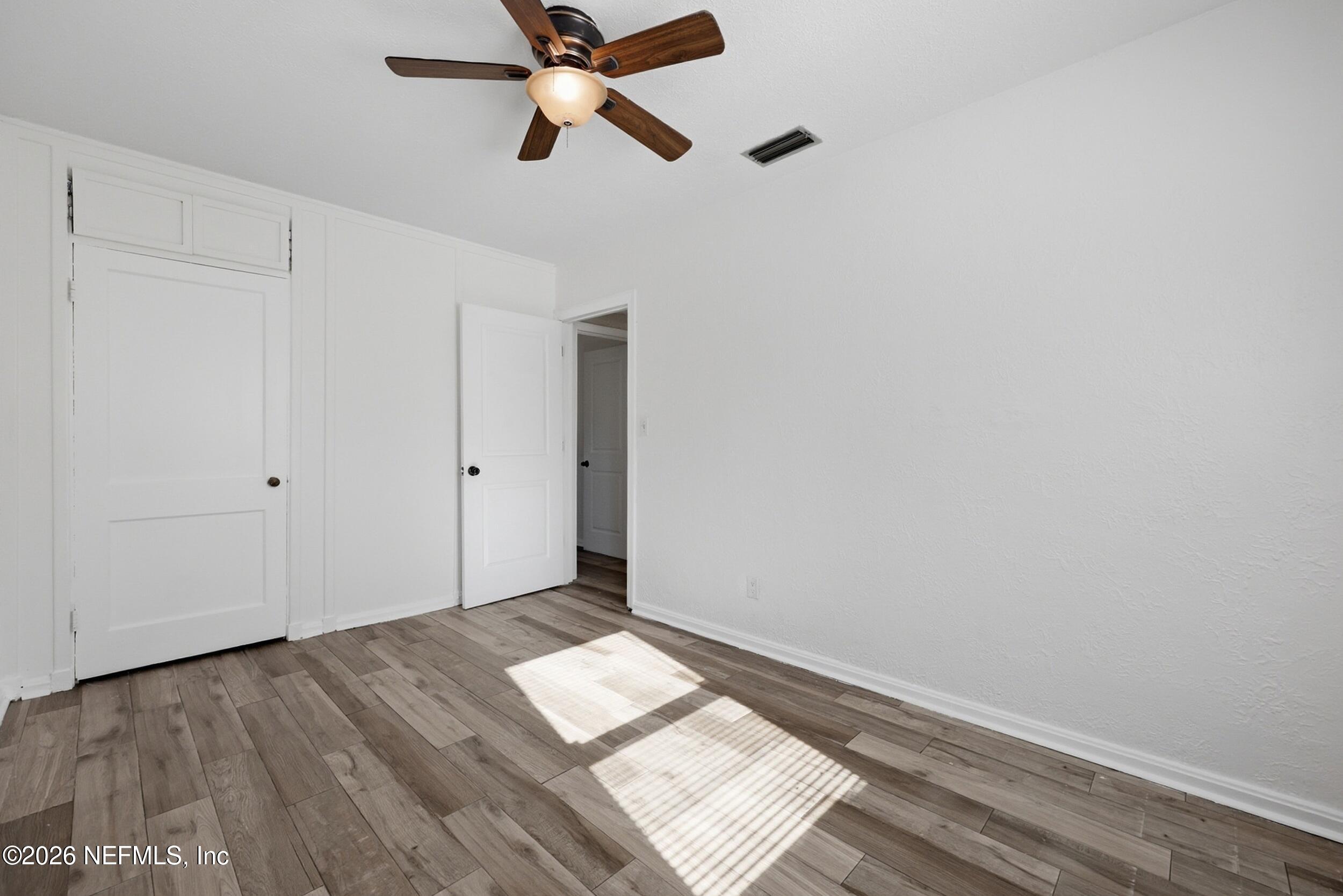 1873 Stanford Road North Jacksonville, FL 32207 - Photo 23 of 37 a view of empty room with wooden floor and fan