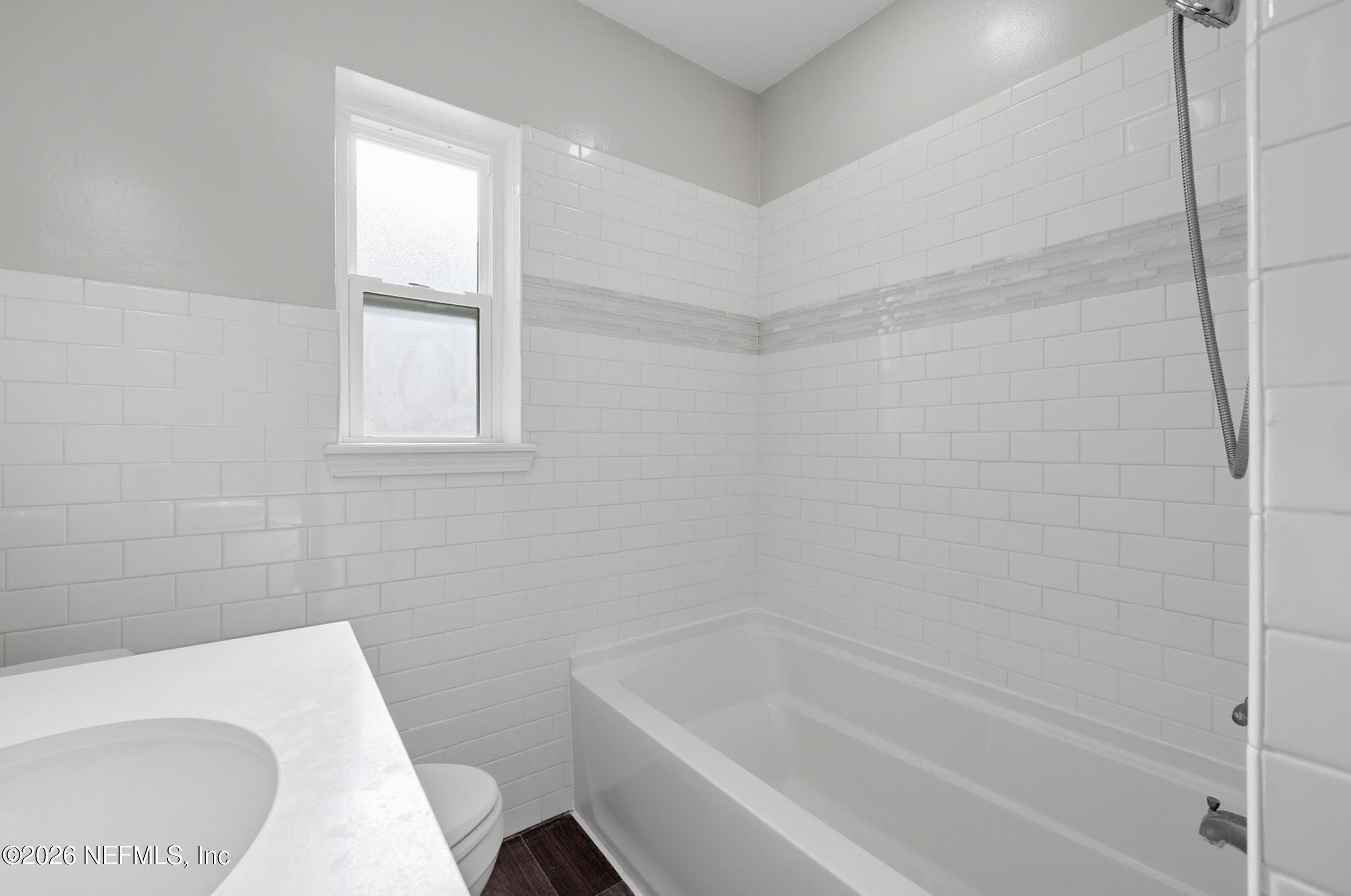 1873 Stanford Road North Jacksonville, FL 32207 - Photo 25 of 37 a bathroom with a bathtub and window