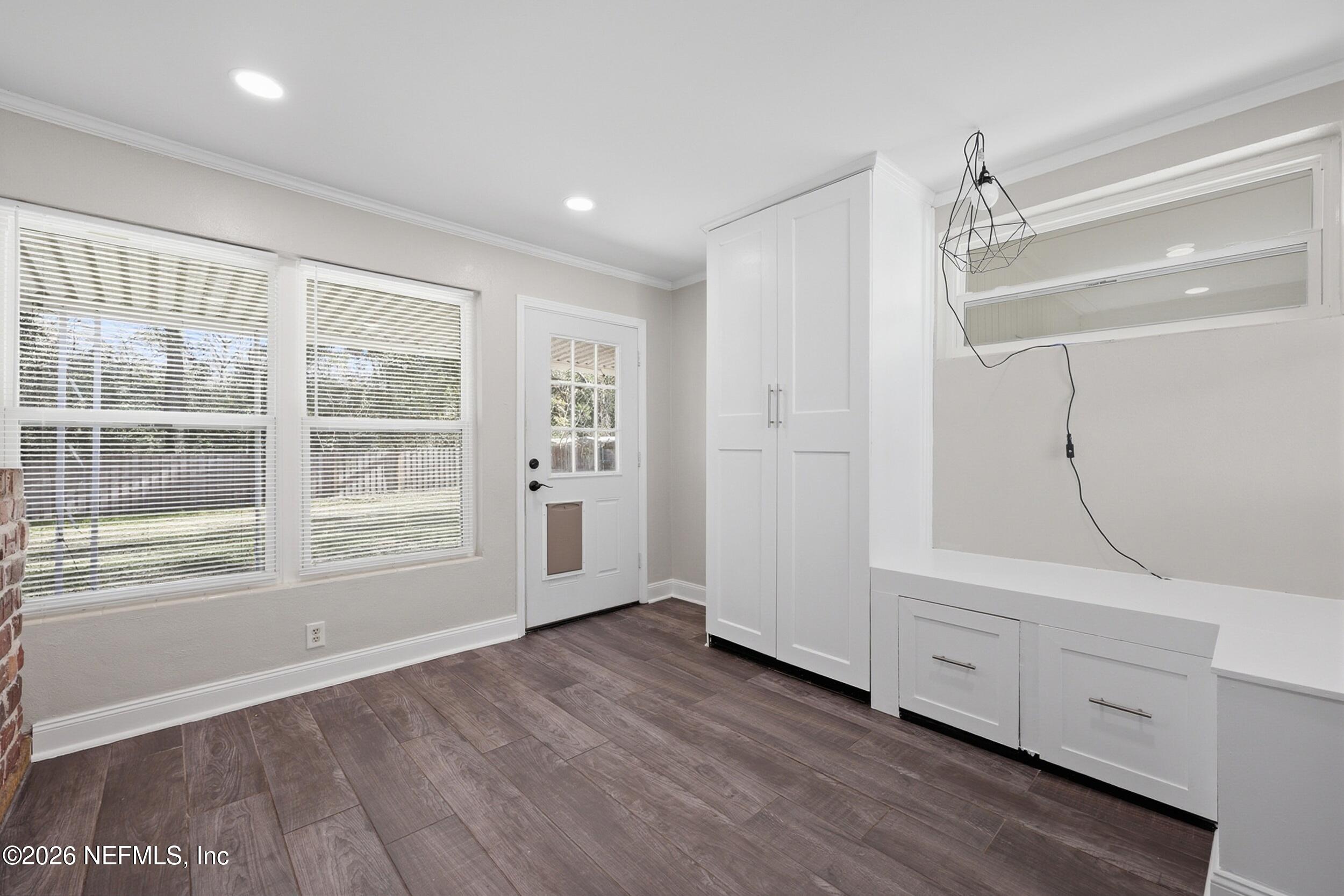 1873 Stanford Road North Jacksonville, FL 32207 - Photo 7 of 37 an empty room with wooden floor and windows