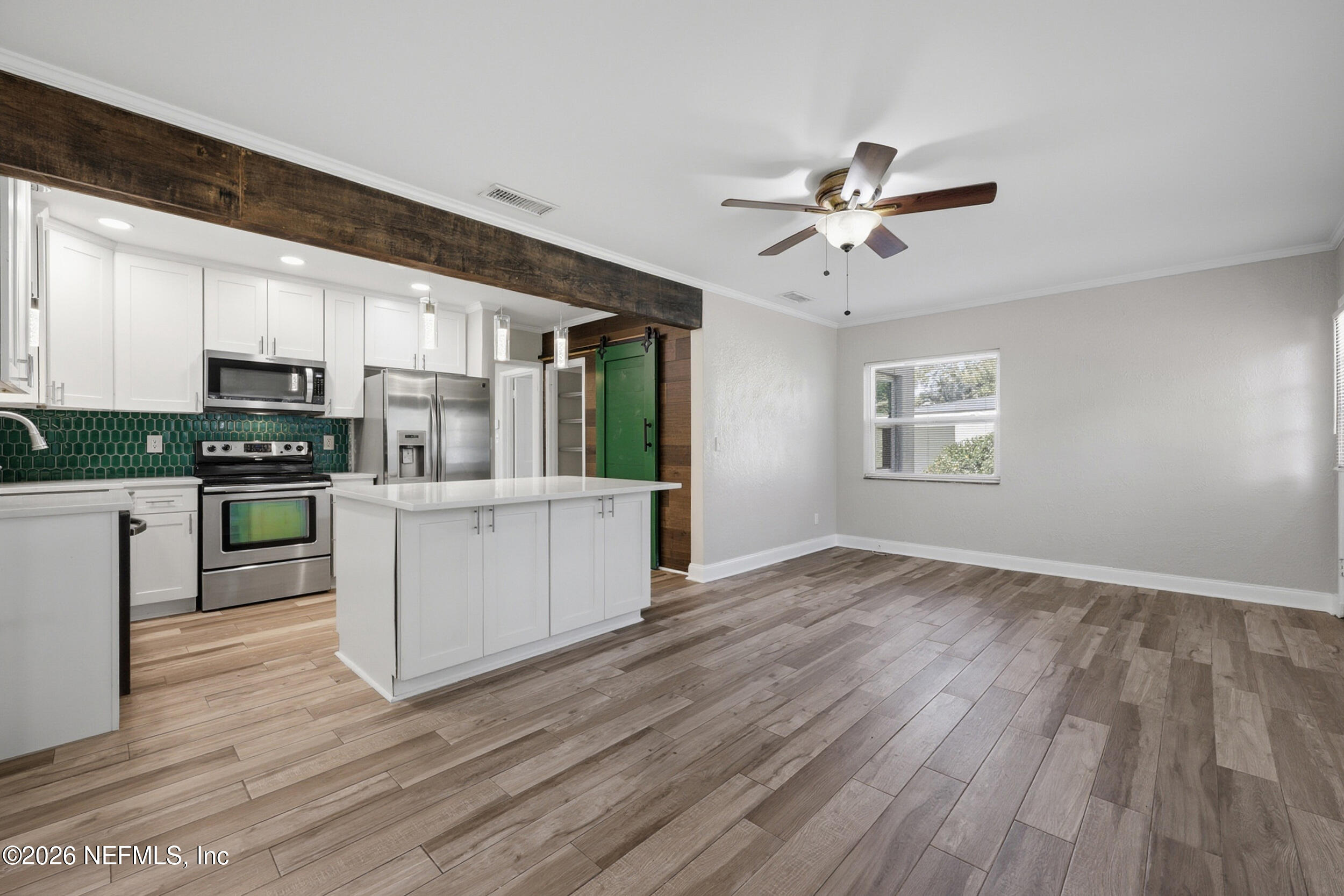 1873 Stanford Road North Jacksonville, FL 32207 - Photo 8 of 37 a kitchen with wooden floors and white cabinets
