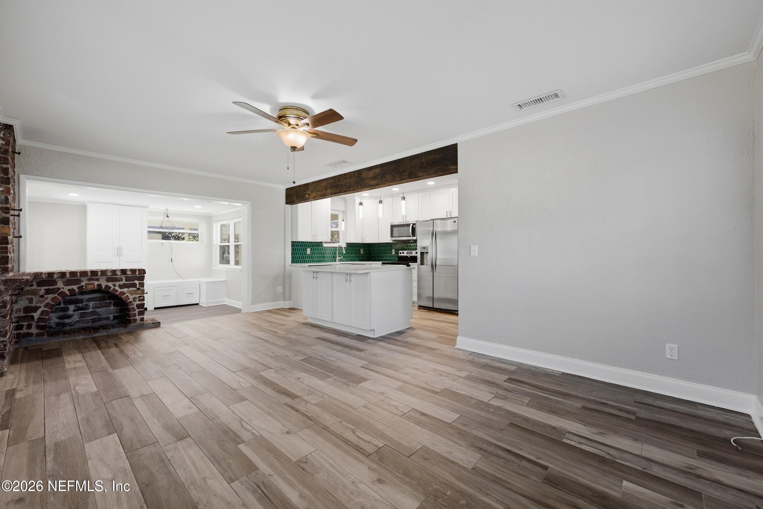 1873 Stanford Road North Jacksonville, FL 32207 - Photo 10 of 37 a view of a kitchen with wooden floor and a ceiling fan