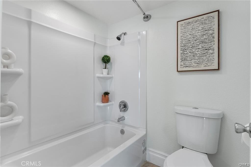 4814 Ranch Road Chino, CA 91710 - Photo 13 of 27 a white toilet sitting next to a bath tub