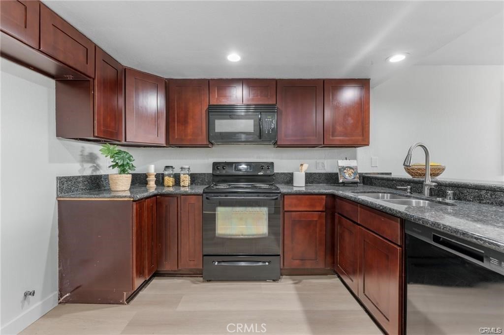 4814 Ranch Road Chino, CA 91710 - Photo 6 of 27 a kitchen with stainless steel appliances granite countertop wooden cabinets a stove top oven a sink and dishwasher