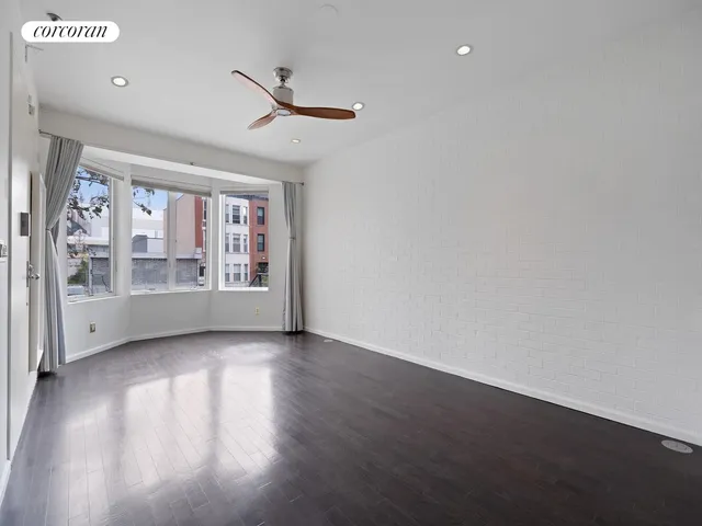 a large kitchen with stainless steel appliances a large counter top and a stove top oven