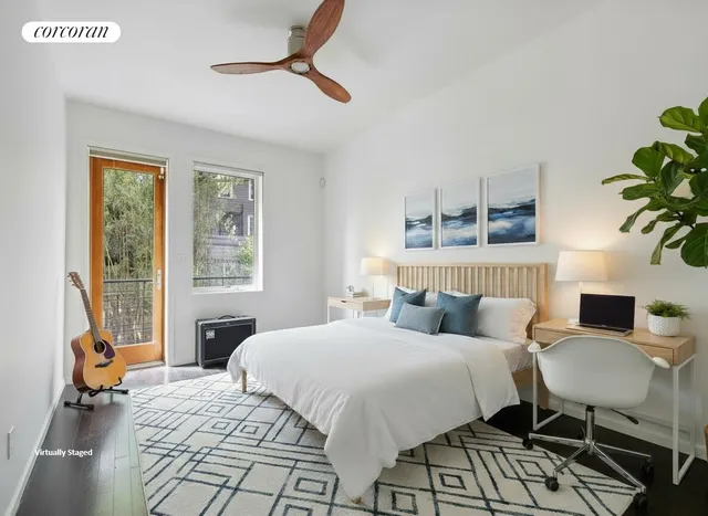 a bedroom with a large bed potted plant and a large window