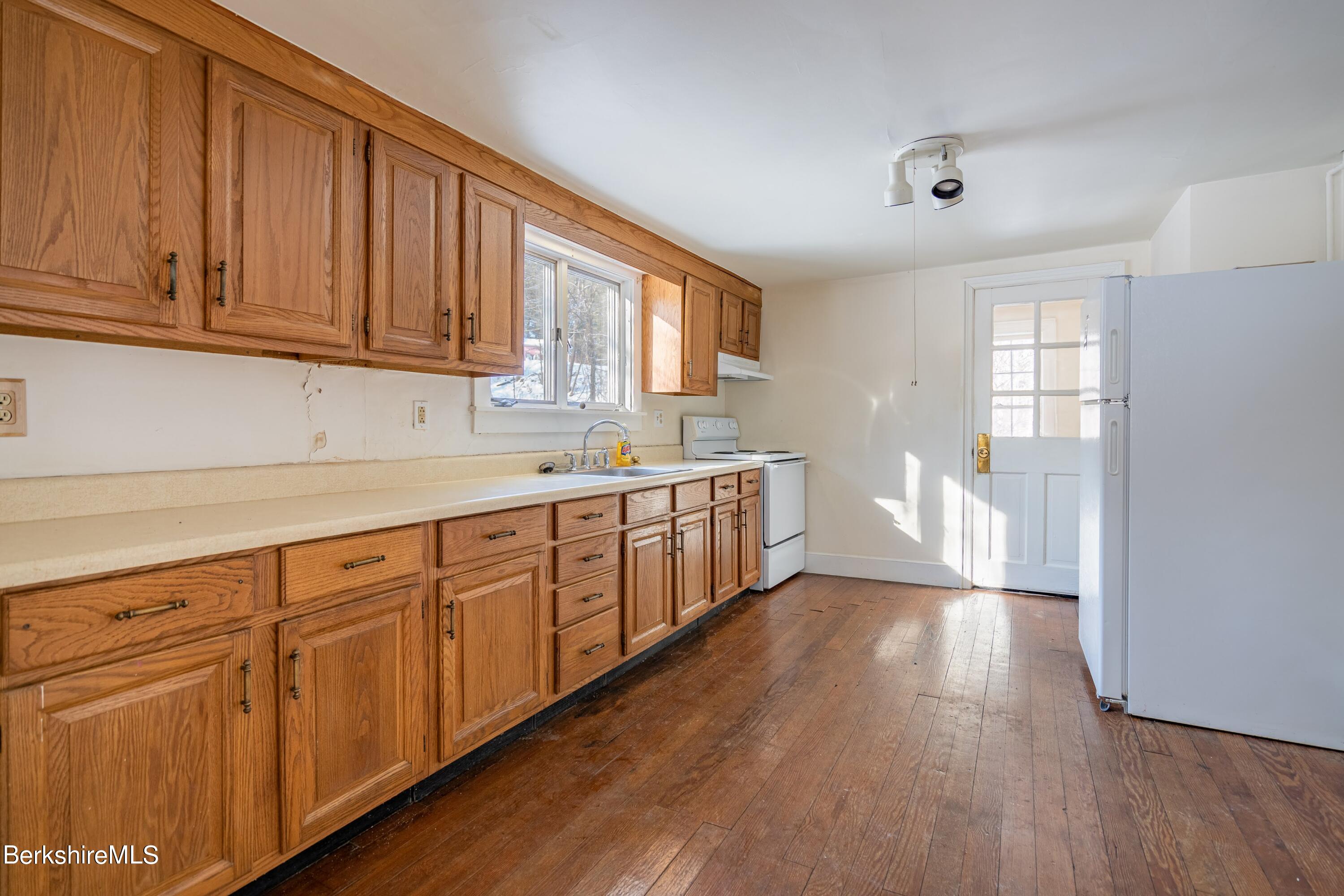 151 Hillsdale Road Egremont, MA 01230 - Photo 11 of 23 a kitchen with stainless steel appliances granite countertop a sink cabinets and wooden floor