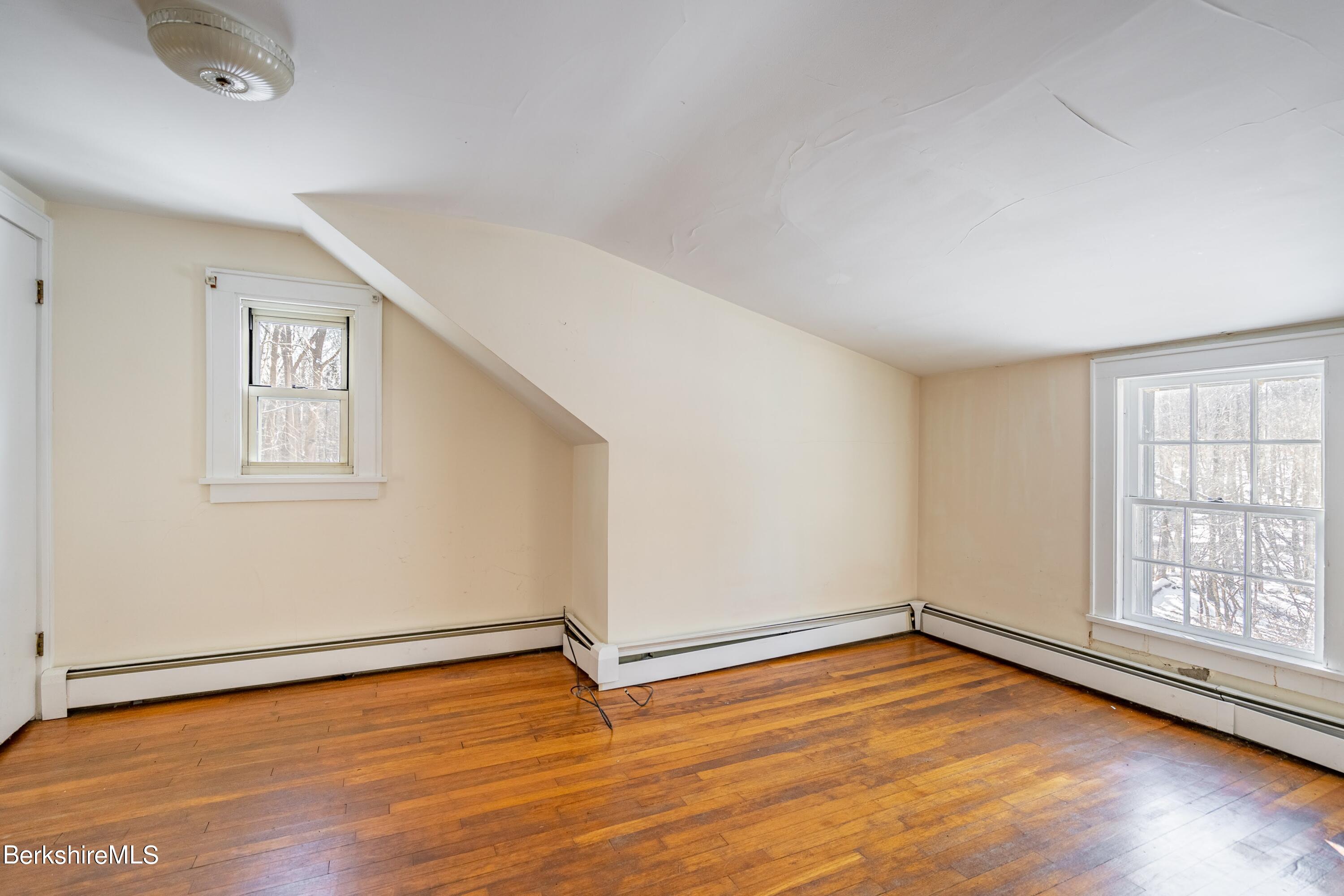 151 Hillsdale Road Egremont, MA 01230 - Photo 15 of 23 an empty room with wooden floor and windows