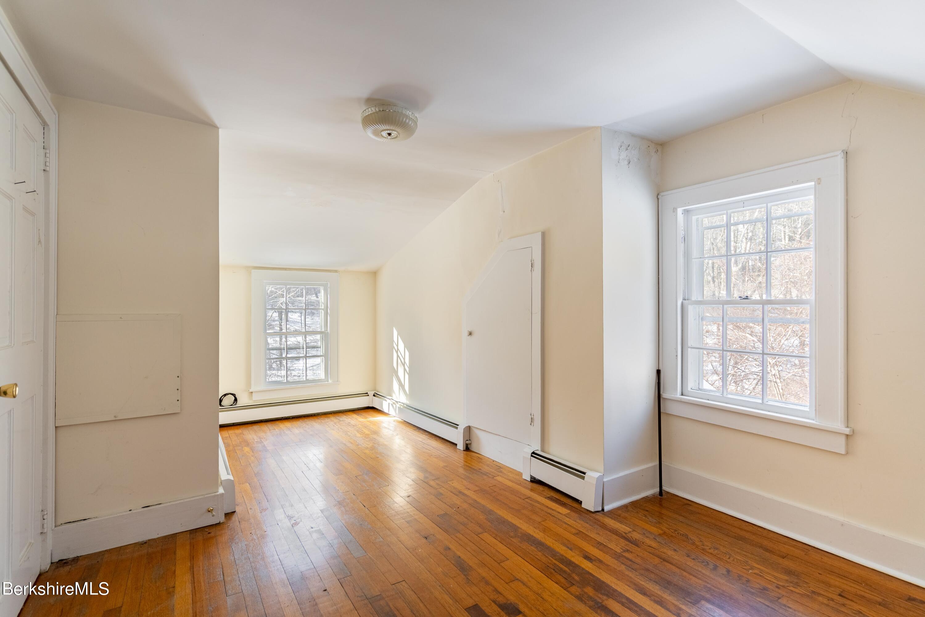151 Hillsdale Road Egremont, MA 01230 - Photo 16 of 23 an empty room with wooden floor and windows