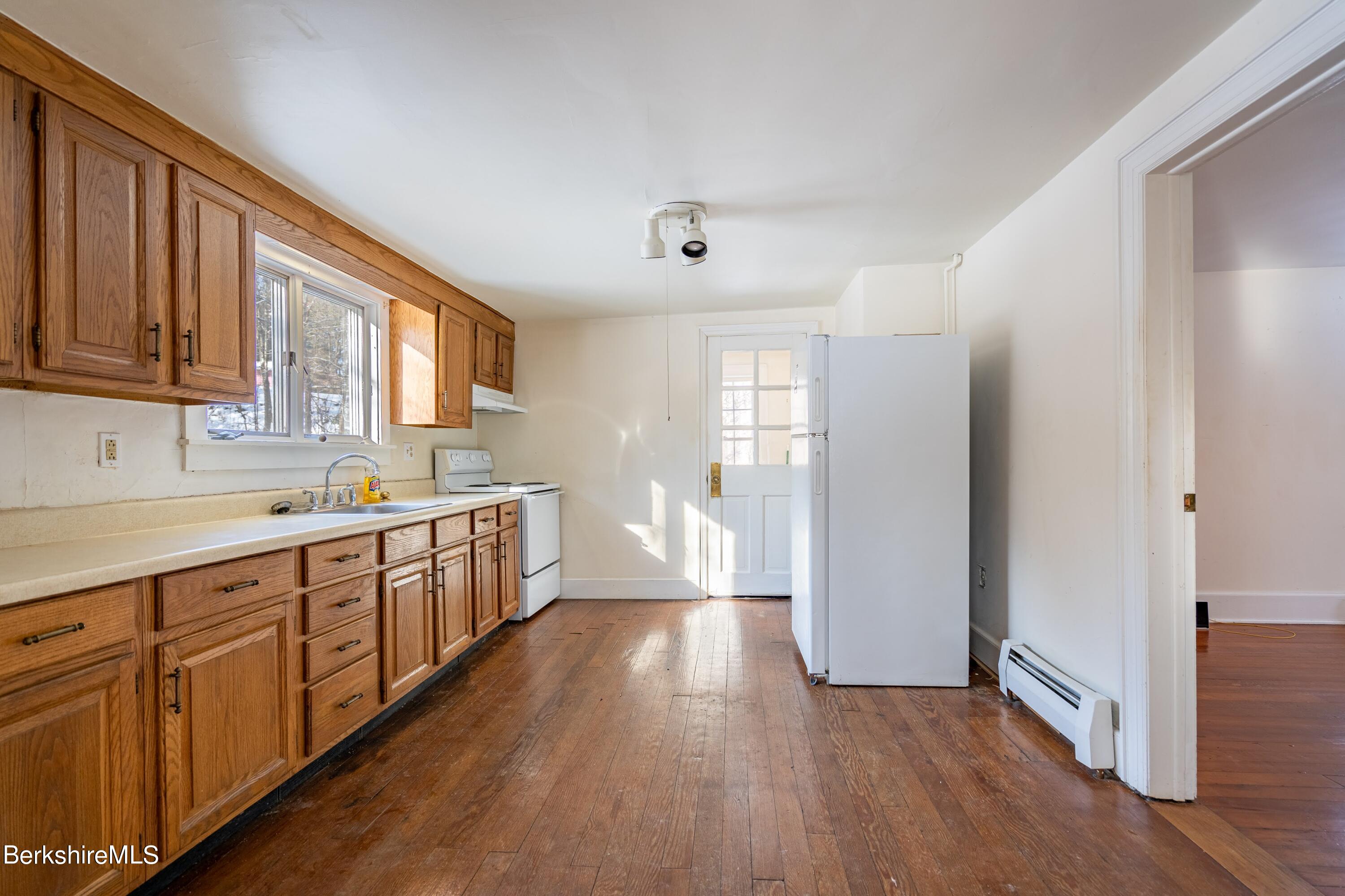 151 Hillsdale Road Egremont, MA 01230 - Photo 8 of 23 a large kitchen with wooden floors and white walls