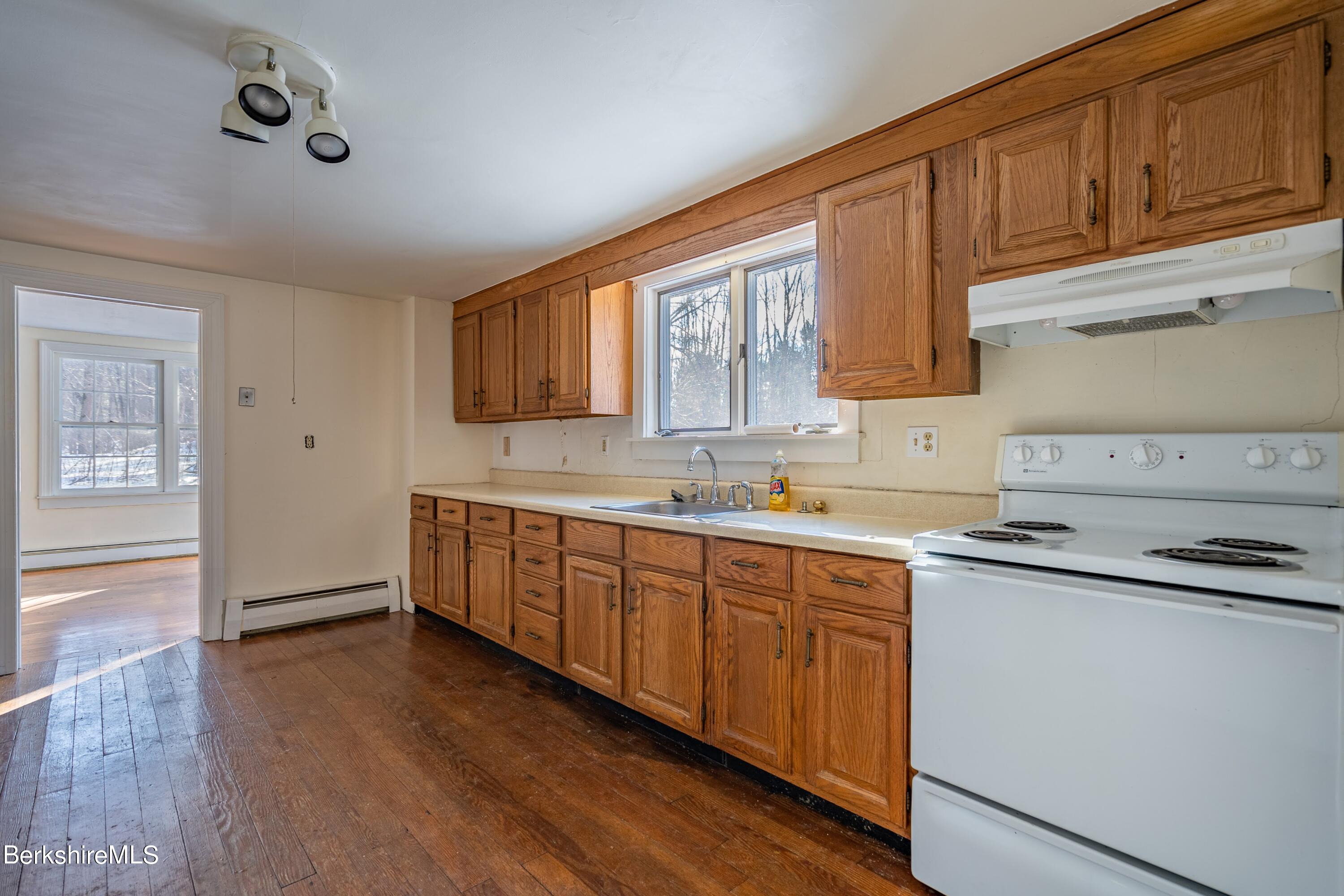 151 Hillsdale Road Egremont, MA 01230 - Photo 10 of 23 a kitchen with stainless steel appliances granite countertop a sink cabinets and wooden floor