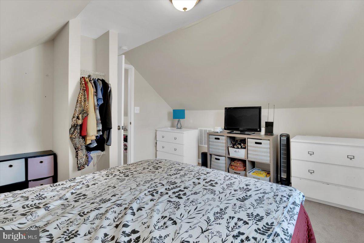 6519 Woodland Road Suitland, MD 20746 - Photo 14 of 35 a bedroom with a bed and a flat screen tv