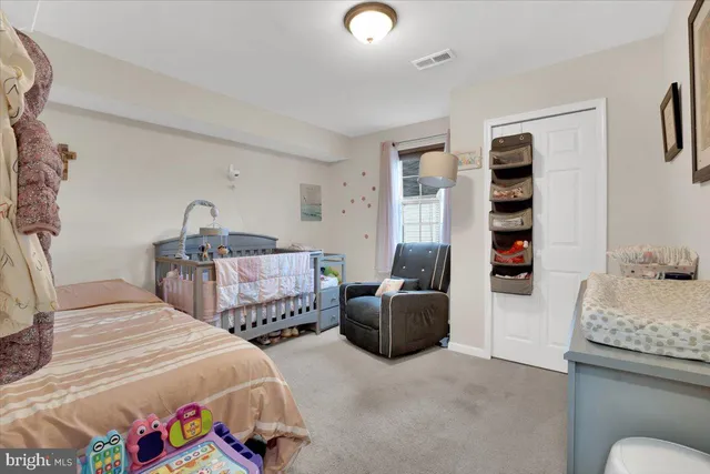 a bedroom with two beds and a chandelier