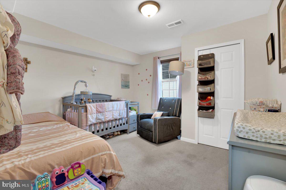 6519 Woodland Road Suitland, MD 20746 - Photo 16 of 35 a bedroom with two beds and a chandelier