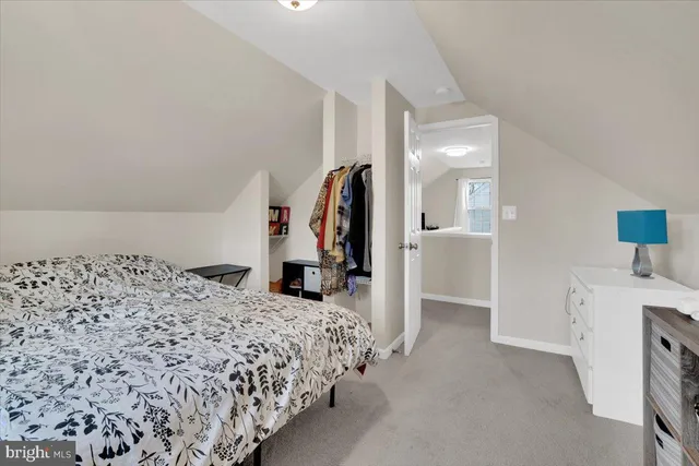 a bed room with a bed and a view of bedroom